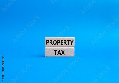 Property Tax symbol. Concept word Property Tax on wooden blocks. Beautiful blue background. Business and Property Tax concept. Copy space