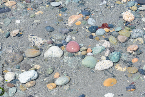 Mixture of natural stones and pebbles in shallow ocean water