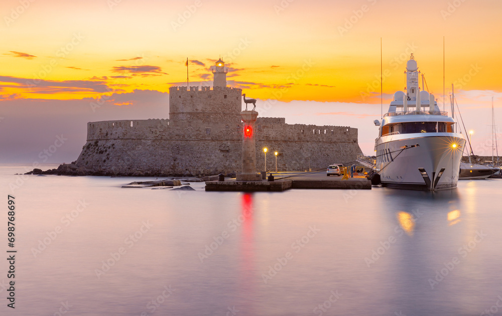 Old stone lighthouse in Fort St. Nicholas in Rhodes early in the morning.