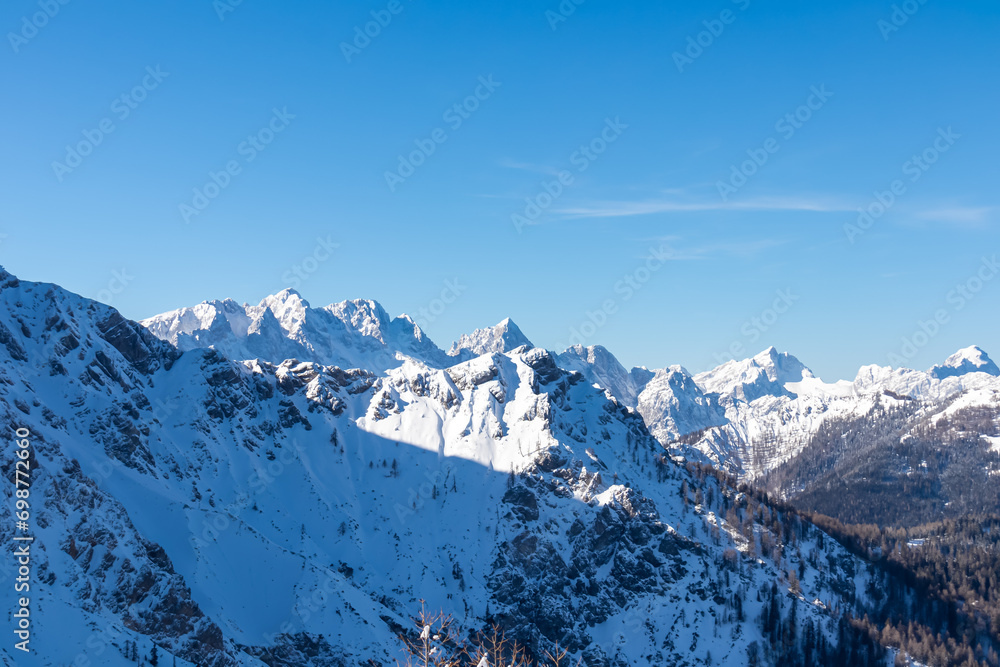 Scenic view from Ferlacher Spitze on snow covered mountains Mangart, Mittagskogel and Spik in Karawanks, Carinthia, Austria.  Winter wonderland in Austrian Alps, Julian Alps and Triglav National Park