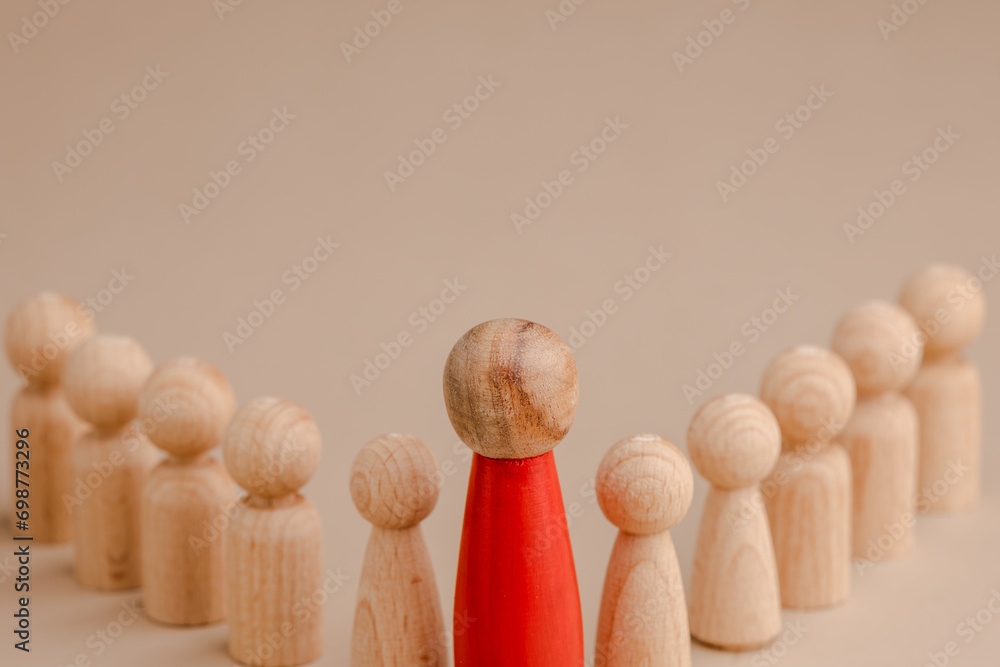 wooden figure representing a leader leading other figures. Leadership concept
 - obrazy, fototapety, plakaty 
