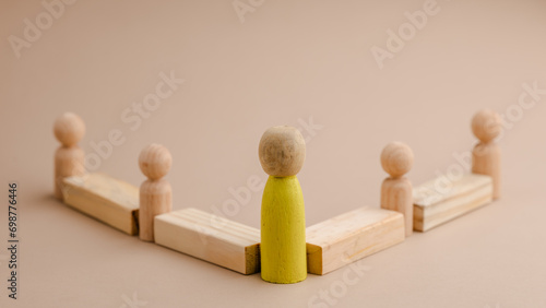 wooden figure representing a leader leading other figures. Leadership concept
