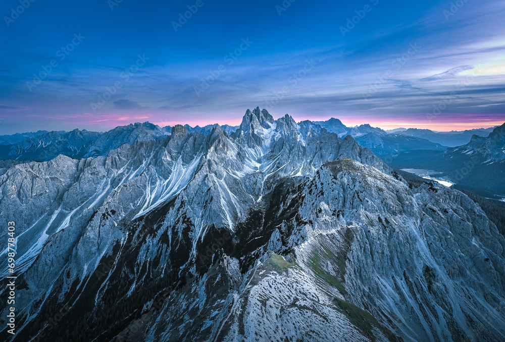 Stunning sunset with colorful sky at Italian Dolomites. Impressive Cadini di Misurina mountain range in autumn colors.