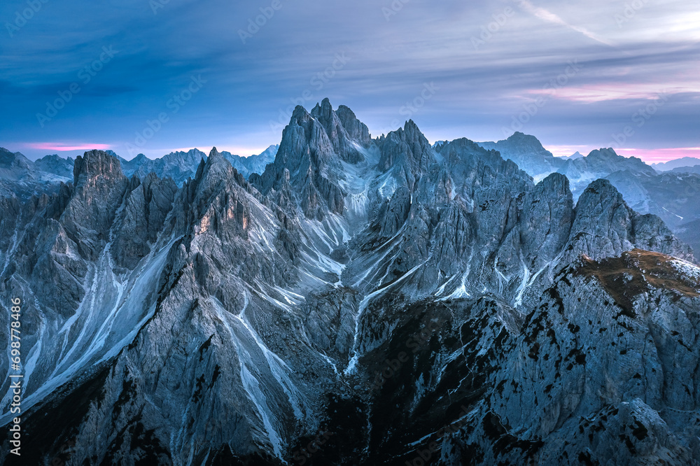 Stunning sunset with colorful sky at Italian Dolomites. Impressive Cadini di Misurina mountain range in autumn colors.