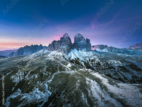 Stunning sunset with colorful sky at Italian Dolomites. Impressive Cadini di Misurina mountain range in autumn colors. 
