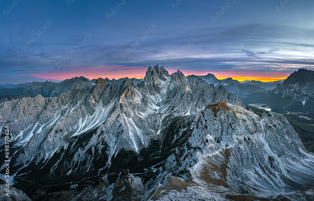 Stunning sunset with colorful sky at Italian Dolomites. Impressive Cadini di Misurina mountain range in autumn colors.