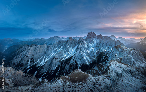 Stunning sunset with colorful sky at Italian Dolomites. Impressive Cadini di Misurina mountain range in autumn colors. 
