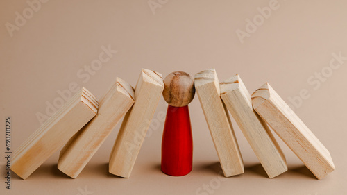 Business professionals stop the crisis domino effect, safeguarding against business collapse.