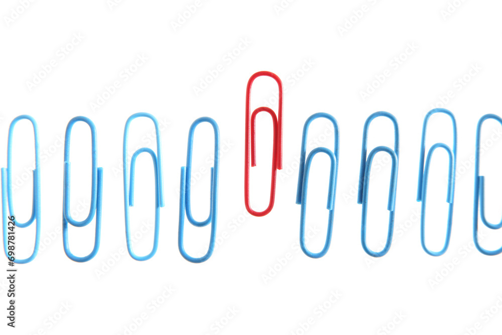 Row of blue paperclips with one unique red one standing out from the others Row of blue paperclips with one unique red one standing out from the others