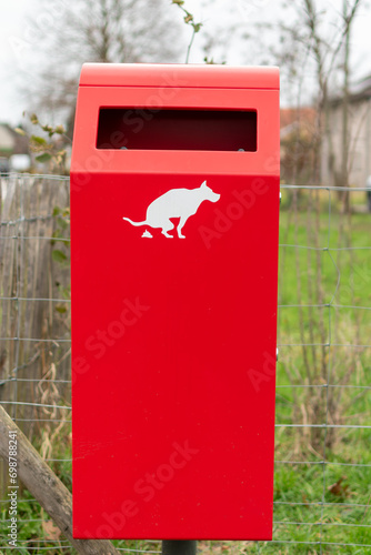 Animal droppings carry diseases. Clean up after your pet. a red bin used for dog excrement