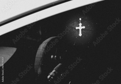 Crucifix on the rearview mirror of a car