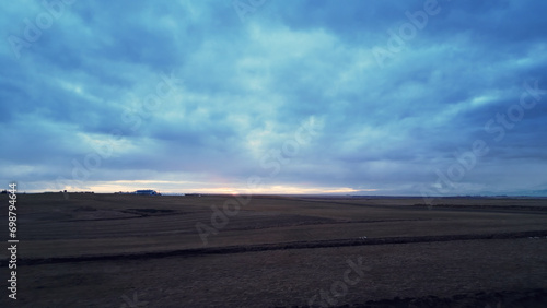 Aerial view of icelandic frosty fields in cold weather  fantastic arctic landscape with snowy mountains and colorful skies. Scandinavian countryside scenery with snow  scenic route.