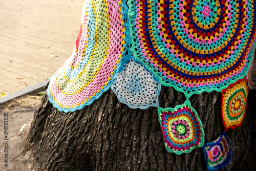 yarnbombing tree with trinkets close-up
