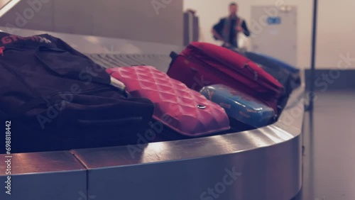 Traveling by airplane. tourists' bags on baggage claim in airport terminal. Wheeled suitcases on a luggage belt at the airport terminal. Baggage carousel. 
