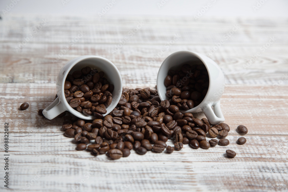 Aromatic coffee seeds and a cup of coffee on a wooden table Aromatic coffee seeds and a cup of coffee on a wooden table