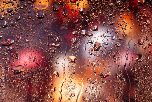 Water drops on glass. Raindrops on the window. Abstract background. Multi-colored spots. Texture of drops