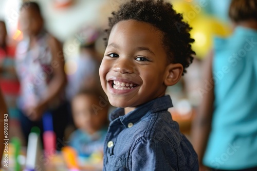 Joyful African American boy with a big smile playing pin the tail at his birthday party
