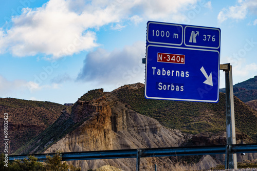 Tabernas desert landscape and road sign, Spain photo