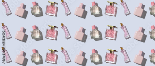 Many bottles of different perfumes on light background. Pattern for design
