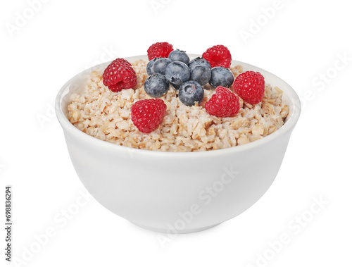 Tasty boiled oatmeal with berries in bowl isolated on white