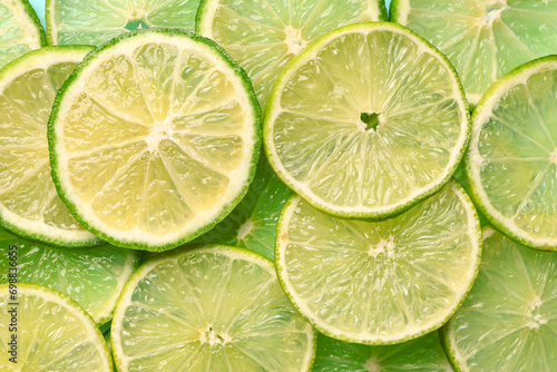 Slices of fresh lime as background, closeup