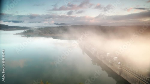 Morning fog over dam on Embalse de Aguilar de Campoo in province of Palencia, Castile and Leon community, northern Spain. photo