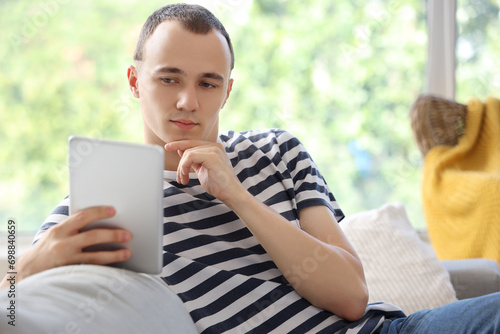Thoughtful young man using ...