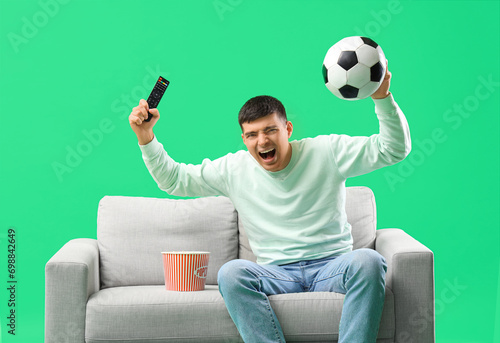 Cheerful young man watching...