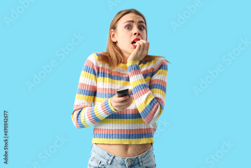 Scared young woman with TV ...