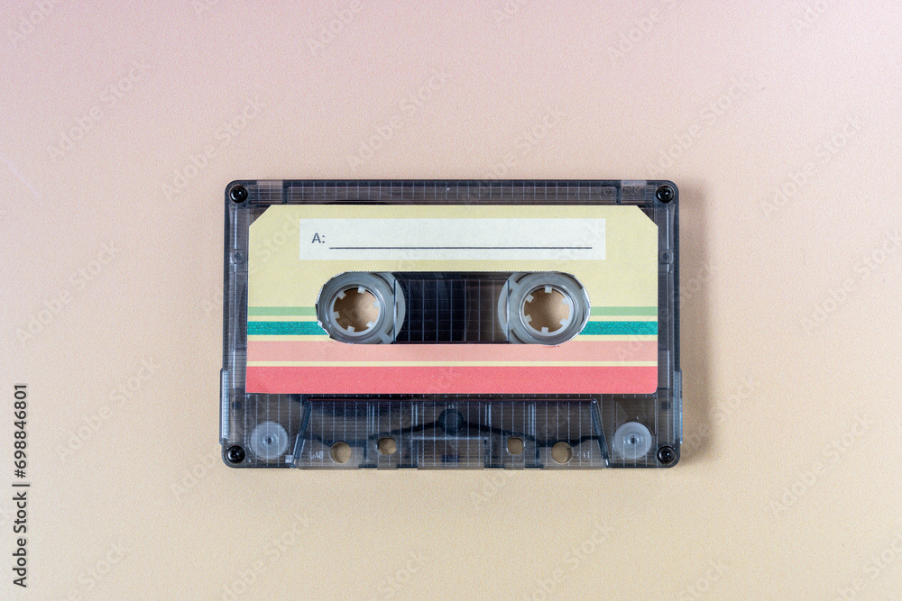Obraz premium Top view of a music cassette on a yellow background.