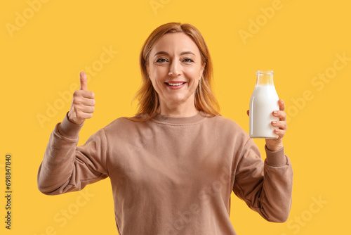 Mature woman with glass of ...