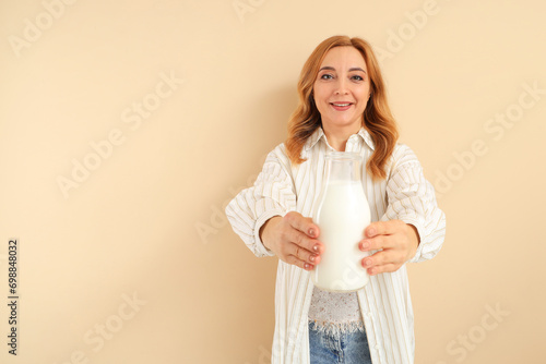 Mature woman with bottle of...