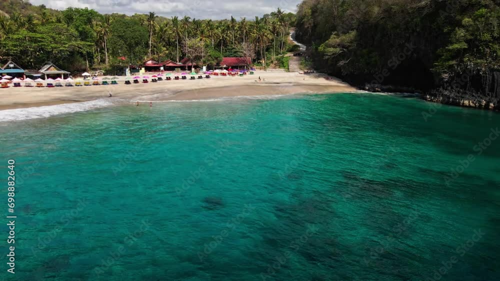Drove revealing beautiful Virgin Beach in East Bali, Karangasem, Indonesia. Dream trip outdoor adventure. Cinematic wild nature aerial 4K. Dense palm tree jungle and transparent green sea waters Drove revealing beautiful Virgin Beach in East Bali, Karangasem, Indonesia. Dream trip outdoor adventure. Cinematic wild nature aerial 4K. Dense palm tree jungle and transparent green sea waters