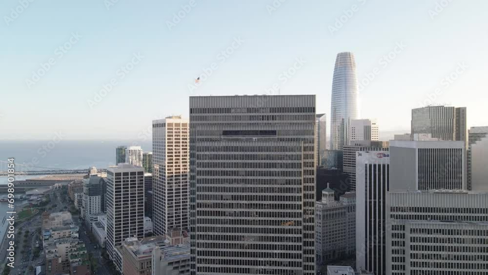 Aerial view of a modern city skyline at dusk with skyscrapers and a waterfront. Aerial view of a modern city skyline at dusk with skyscrapers and a waterfront.