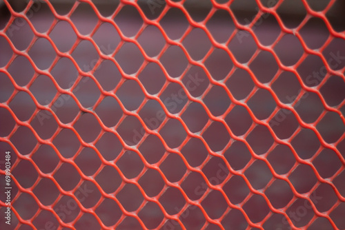 Red plastic fence and blurred background