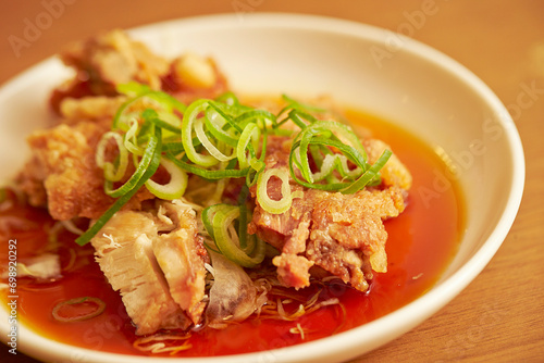 Fried chicken with green onion on a plate