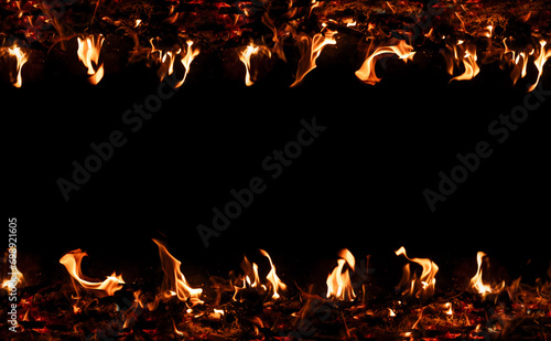 Fire flames on black background. Blazing campfire isolated on dark background.