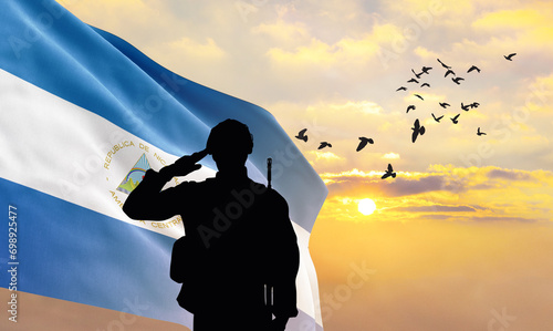 Silhouette of a soldier with the Nicaragua flag stands against the background of a sunset or sunrise. Concept of national holidays. Commemoration Day.