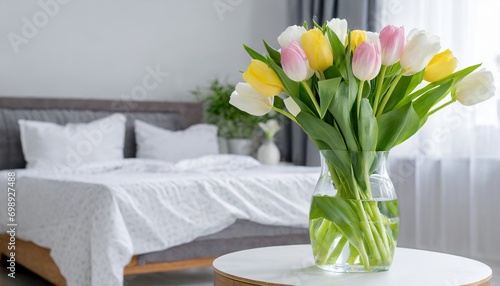 Bouquet of tulips in glass vase in bedroom