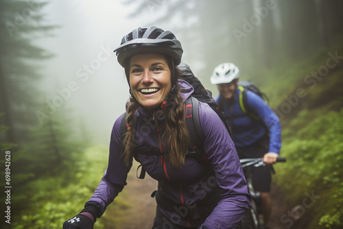 Small happy group of cyclers exploring forest in the autumn enjoying trip photo