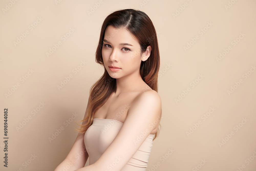 Obraz premium Beautiful young asian woman with clean fresh skin on beige background, Face care, Facial treatment, Cosmetology, beauty and spa, Asian women portrait.