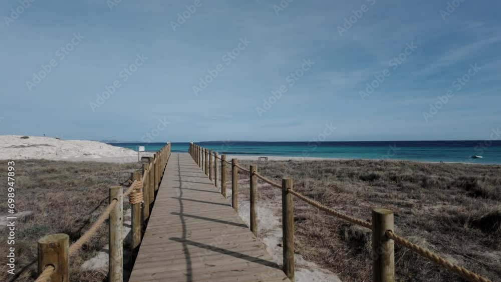 Serene Walk on a Wooden Boardwalk Among Pristine Beach Dunes