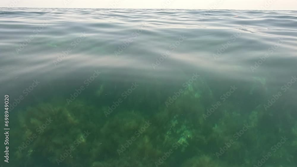 Sea water surface background. Low angle view from kayak, camera flies over the clear green sea water. Nobody. Holiday recreation concept. Abstract nautical summer ocean nature. Slow motion. Sea water surface background. Low angle view from kayak, camera flies over the clear green sea water. Nobody. Holiday recreation concept. Abstract nautical summer ocean nature. Slow motion.