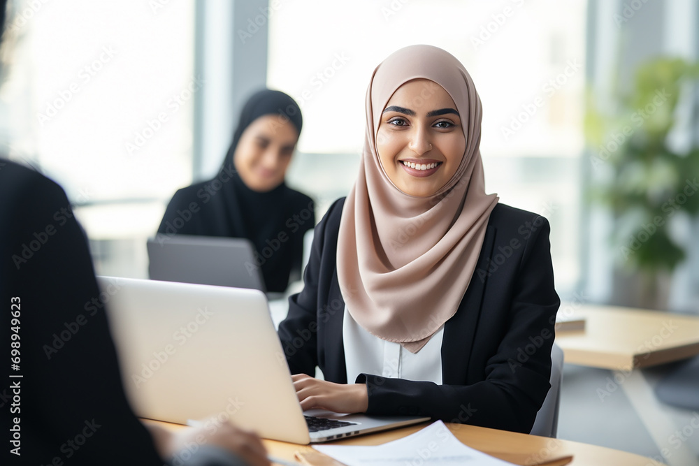 Asian Muslim female hr manager wearing hijab giving interview