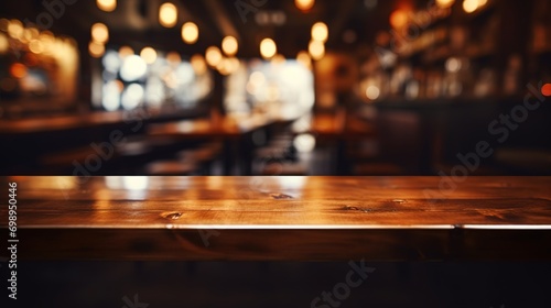 Empty wooden bar table, against blurred bokeh background of a cafe or pub