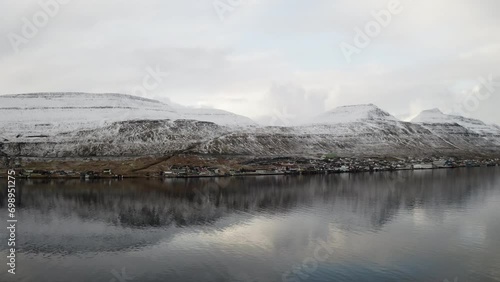 Faroe Islands, 4K Aerial of Skali town perched on the edge of the water. photo