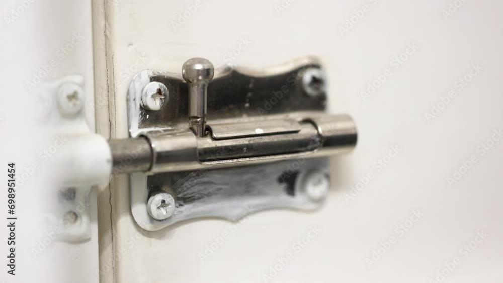 Locking a door correctly with a simple latch on a closer view. Locking a door correctly with a simple latch on a closer view.