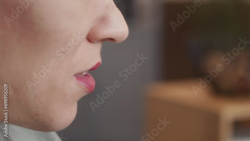 Tilt up side view closeup of Caucasian little woman reading book hushfully at home