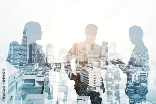 Creative city skyline with businesspeople silhouettes on light backdrop. Teamwork  partnership and success concept. Toned image. Double exposure