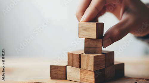 Concept of business process and workflow automation with flowchart. Hand holding wooden cube block symbolize management process